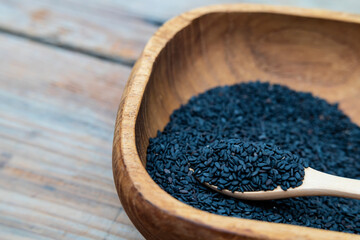 Heap of black Sesame close-up shot on wooden background