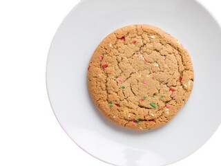 Almond giant biscuits with coloured sugar pieces on a white platter