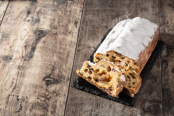 Christmas stollen fruit cake on wooden table. Copy space