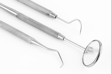 Dentist's tools inclined on a white background