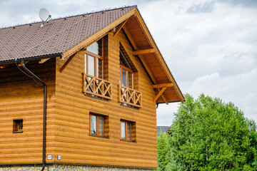 Modern wooden house with big windows in the suburb. Building of houses for the key. Cottage or pension near the forest in countryside