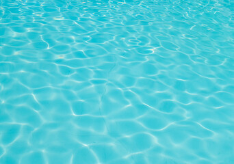 Fototapeta na wymiar Blue tiles swimming pool water reflection texture.