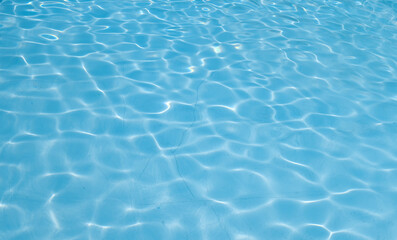 Fototapeta na wymiar Beautiful ripple wave and blue water surface in swimming pool. Blue water surface background.