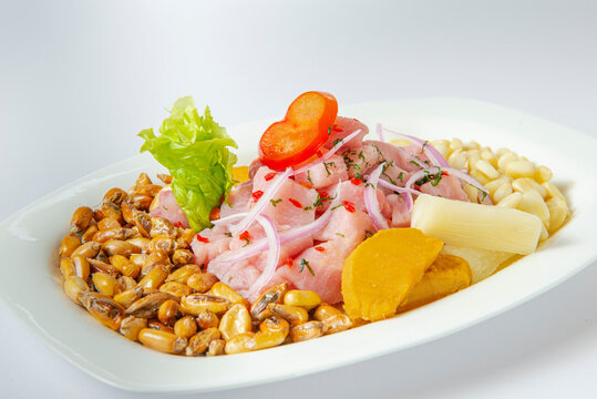 Delicious seafood ceviche from Peru with chili peppers, chickpeas. White background.