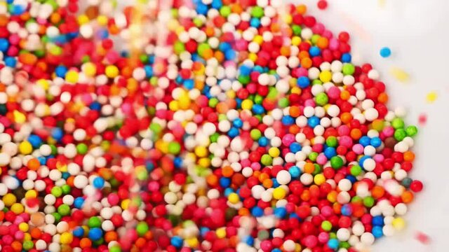 Sweet candy many&nbsp;colors drop into clear cups, Food concept.