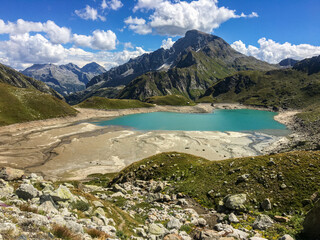 Naklejka na ściany i meble Panoramic view of an alpine lake between the rocks.