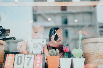 Young mother relaxing together with her little child,in summer
