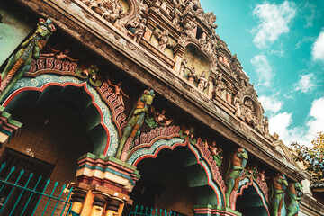 Hindu temple full of colorful ornaments against a blue sky on a sunny day.  © insomniafoto
