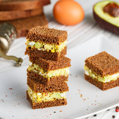 Rye bread sandwiches with eggs and avocado. Delicious and healthy Breakfast for gourmets. Diet. Good nutrition. Selective focus