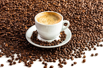 Cup with coffee on the background of coffee beans