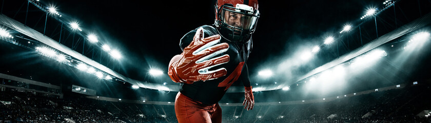 American football player, athlete sportsman in red helmet on stadium background. Sport and motivation wallpaper. Wide photo.