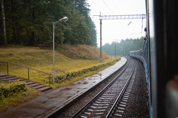 view of the railway tracks from the train car. travel in autumn by train