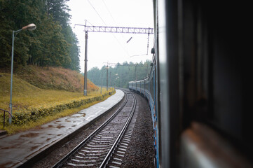 view of the railway tracks from the train car. travel in autumn by train