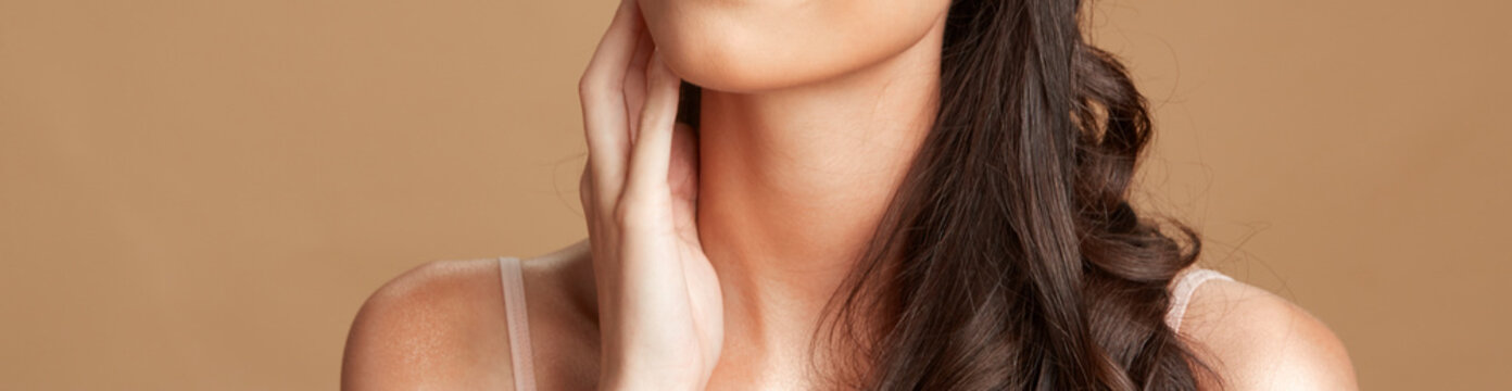 beauty image of flawless skin of women with her hand on her chin