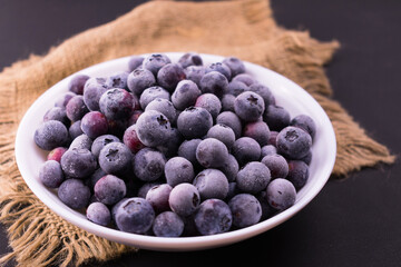 
Frozen blueberries in a plate.
Close-up.