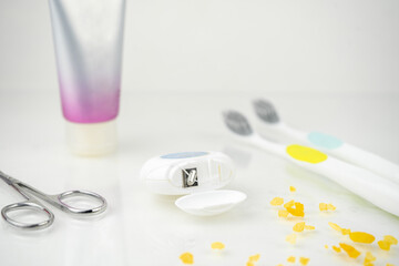 dental floss, toothpaste, toothbrush, daily dental care concept on white background