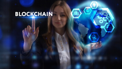 Business, Technology, Internet and network concept. Young businessman working on a virtual screen of the future and sees the inscription: Blockchain