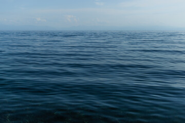 clear calm dark blue water surface of lake baikal, morning ripples