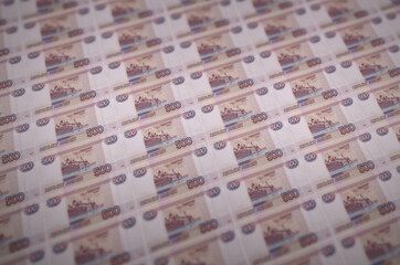 500 russian rubles bills printed in illegal money production conveyor. Collage of many fake bills....