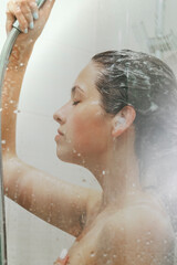 Young woman taking shower. Concept of simple pleasures, relaxing and healthcare