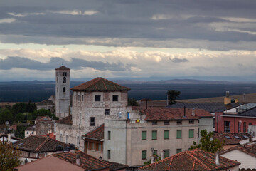 Houses and old church of Cuellar, sunset with clouds. In Cuellar, Segovia. Castilla y Le&oacute;n, Spain.