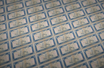 5 Ukrainian hryvnias bills printed in illegal money production conveyor. Collage of many fake...