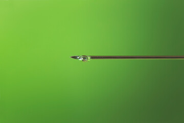 detail of syringe needle with a drop of medicine