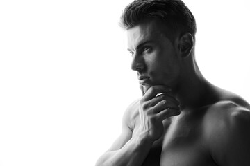 Fototapeta na wymiar Muscular sexy model sports young man on white background. Black and white portrait of beautiful healthy guy.