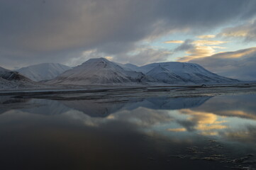 Fototapeta premium Sunset reflections over the frozen Arctic Norwegian Archepelago of Svalbard, Norway