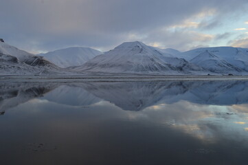 Sunset reflections over the frozen Arctic Norwegian Archepelago of Svalbard, Norway