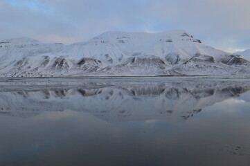 Sunset reflections over the frozen Arctic Norwegian Archepelago of Svalbard, Norway