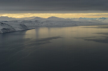 Sunset reflections over the frozen Arctic Norwegian Archepelago of Svalbard, Norway