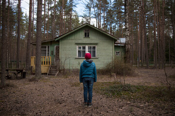 Stranger Things.Mysterious boy in front of a cabin in the woods.