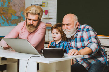 Home education concept. Learning online. Father, Grandfather and child son together.