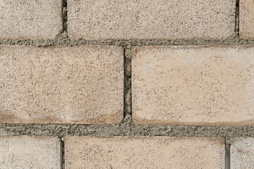 Wall of big brick white texture background. Texture of a brown stone wall construction.
