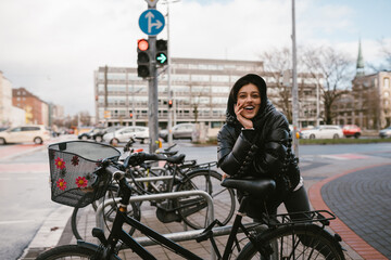 Young woman posing in a parking lot with bicycles © teksomolika