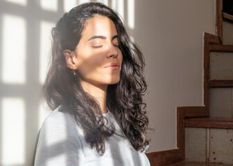 In quarantine a brunette woman takes the opportunity to sunbath inside her home in the pandemic...
