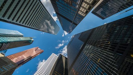 Business and finance concept, time lapse view looking up at office building architecture in the financial district, Toronto, Ontario, Canada. - Powered by Adobe