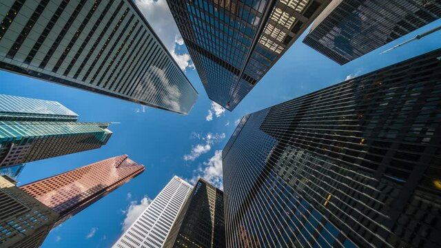 Business and finance concept, time lapse view looking up at office building architecture in the financial district, Toronto, Ontario, Canada.