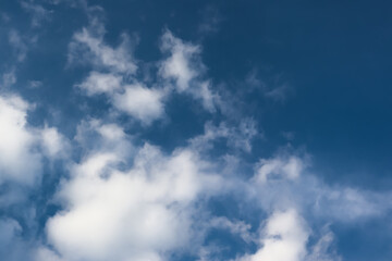 White cotton wool clouds on a sunny day. A continuous stream of clouds across the summer sky.