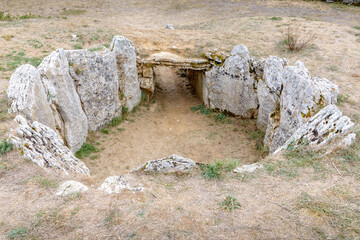 Dolmen La Cabana with cloudy sky in Sargentes de Lora, Burgos, Castilla y Leon, Spain