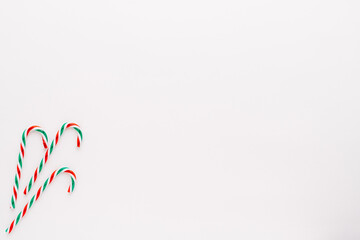 Traditional christmas sweets, candy cane sweets on white background, simple pattern, layout, on white background, top view.minimal concept