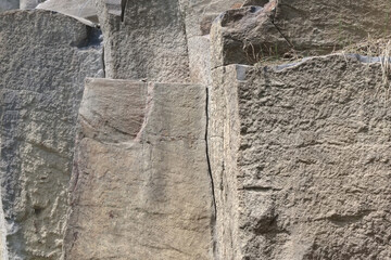 Wall of big basalt pillars in quarry. Building raw materials.