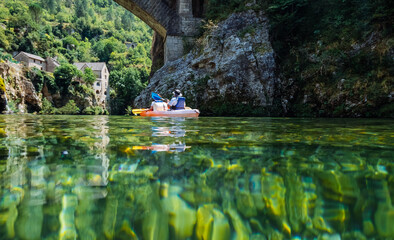 Couple paddles a kayak on the river Tarn. Gorges du Tarn, France - obrazy, fototapety, plakaty