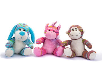 Stuffed animals sitting on white background.