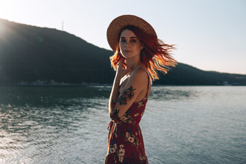 young woman in a hat on the beach