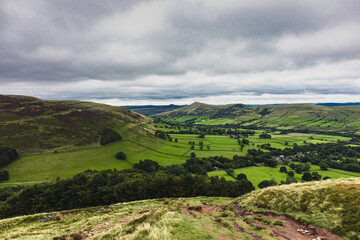 Fototapeta na wymiar English countryside on a cloudy day. Green lush valley.