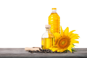 Bottles of sunflower oil with seeds and sunflower on wooden table isolated on white background - 376751320