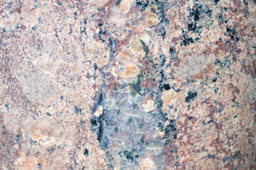 A cracked gray stone with pink veins. Marble surface. Beautiful patterns and lines.