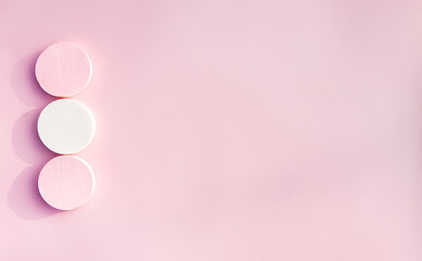 Cosmetic sponges in pastel colors on a pink background